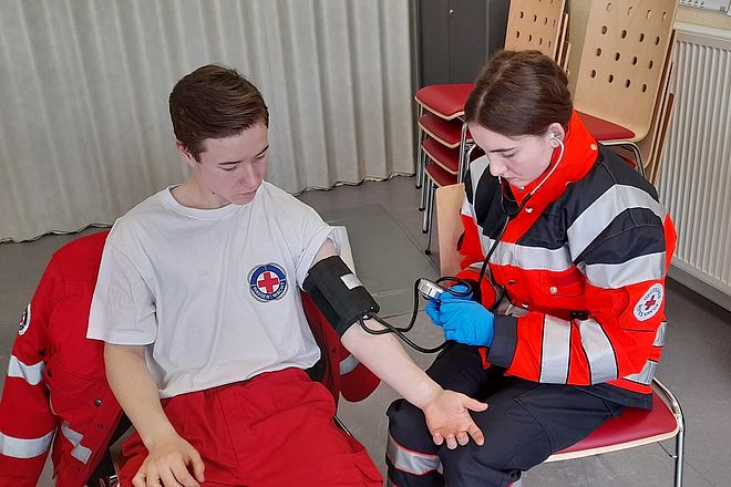 Eine Einsatzkraft übt das Blutdruckmessen im Rahmen einer Sanitätsdienstausbildung im März 2023 in Verden.